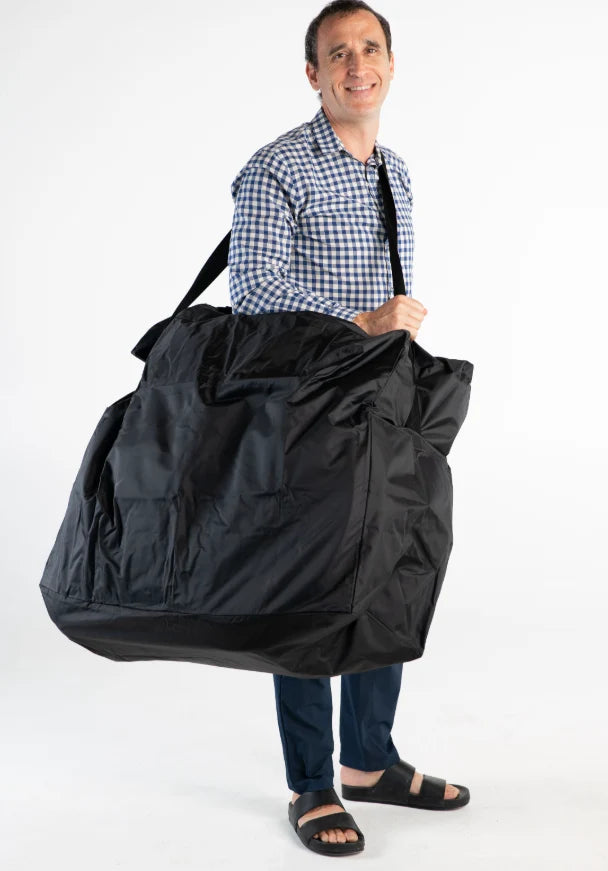 Man holding a large black bag against a white background
