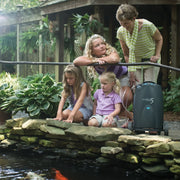 Woman and children by a pond with a concentrator device.